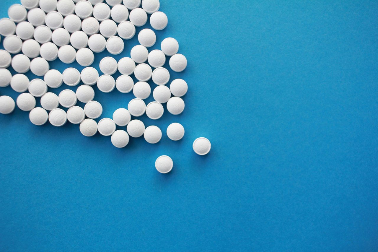 White tablets arranged on a blue background