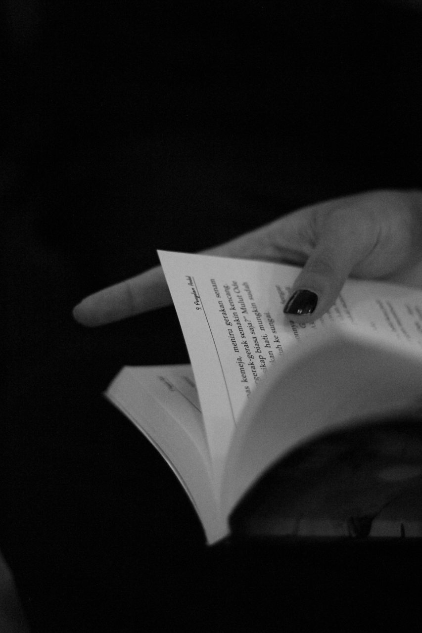 Hands holding an open book